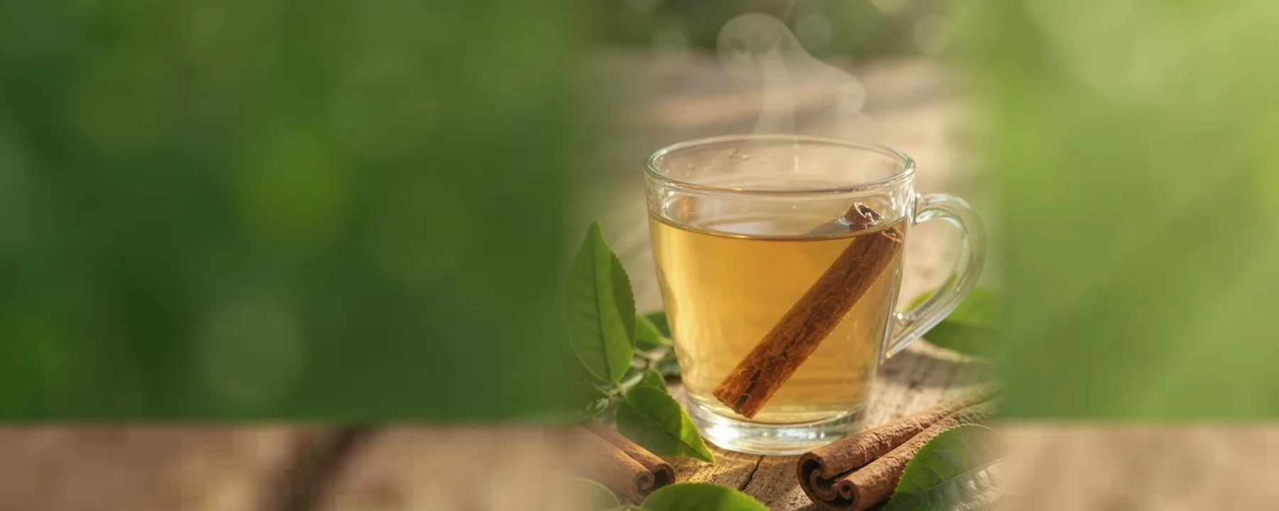 Steaming tea on a wooden table surrounded by botanical leaves