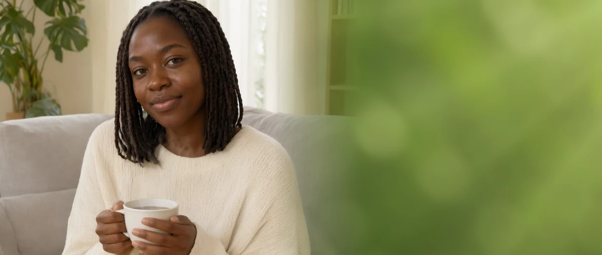 A woman enjoying a cup of tea at home